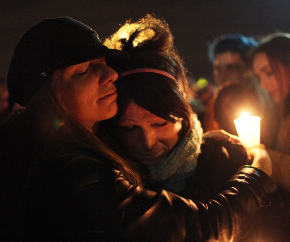 Tiffany Neri, left, embraces Cassie Thompson during a group hug at the end of a vigil to remember the life of Leelah Alcorn, a 17-year-old transgender girl who committed suicide in Ohio. “My death needs to mean something,” she said in her final message.
