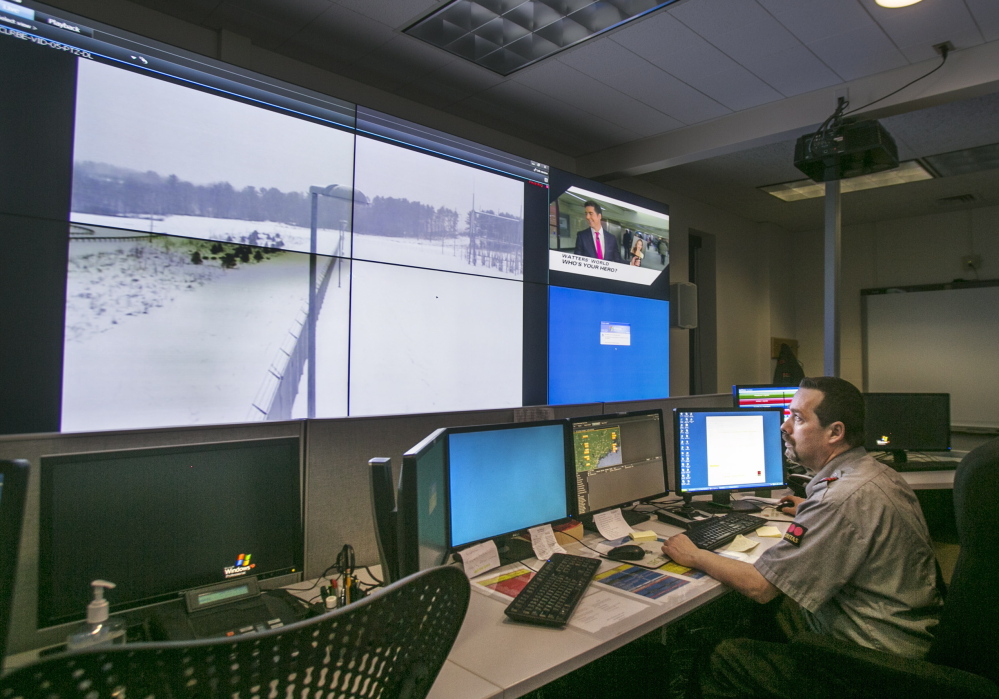 Shane McKenzie of Securitas monitors a screen at Central Maine Power’s new security operations center in Augusta. A perimeter view of the Albion substation is transmitted by video cameras.