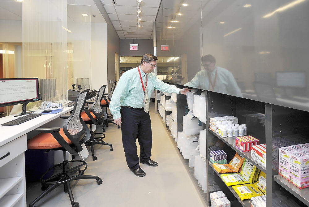 William Hewitt organizes the front end of the state’s first 24-hour pharmacy at Maine Medical Center before Monday’s official opening.