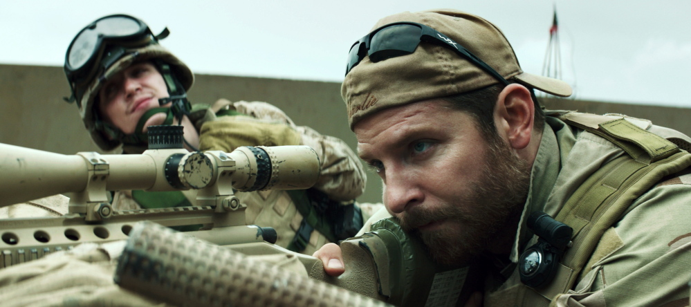 Kyle Gallner, left, and Bradley Cooper appear in a scene from “American Sniper.”