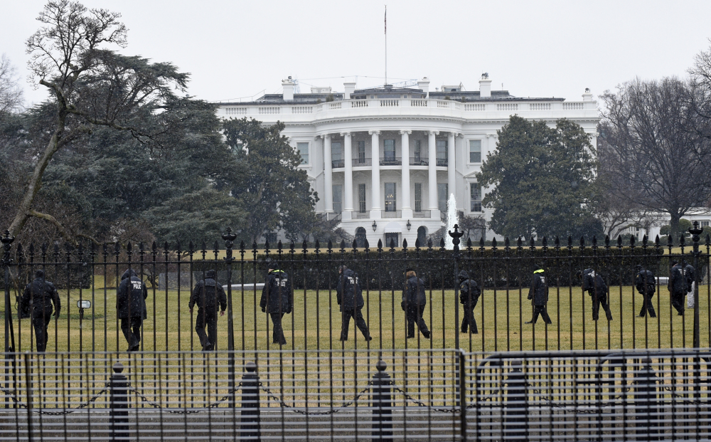 Secret Service officers search the south grounds of the White House in Washington on Jan. 26 after a drone was found during the middle of the night. President Barack Obama and the first lady were in India at the time. The Associated Press