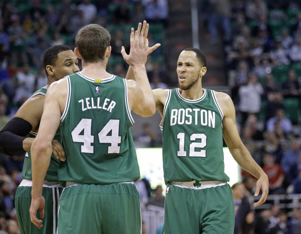 Celtics newcomer Tayshaun Prince (12) high-fives Tyler Zeller in the fourth quarter of Monday night’s game in Salt Lake City. The Celtics won, 99-90, as Prince scored 19 points.