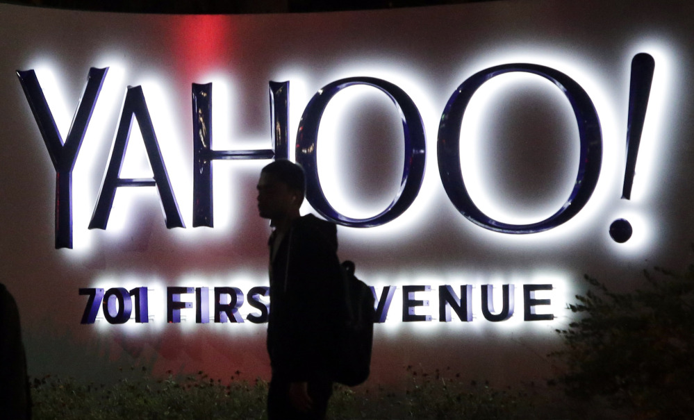 A pedestrian is silhouetted against a sign at Yahoo's headquarters in Sunnyvale, Calif. 