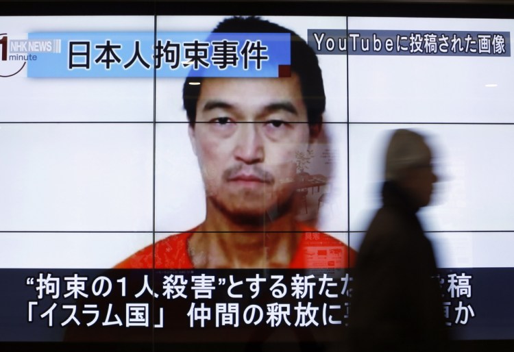 A news screen in Tokyo displays an image of Kenji Goto, a Japanese journalist captured by Islamic State militants. Indirect talks through religious and tribal leaders in Iraq are under way to free the hostages.