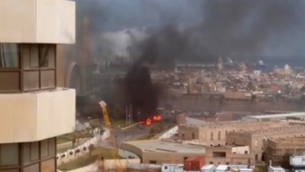 In this image made from video posted by a Libyan blogger, the Corinthia Hotel in Tripoli, Libya, is seen under attack Tuesday. Gunmen stormed the luxury hotel, killing several foreigners and guards, officials said.