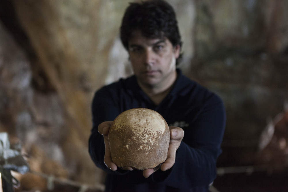 Dr. Omry Barzilai of Israel’s Antiquities Authority holds an ancient skull found in a cave near the northern city of Nahariya. The skull dates from around 55,000 years ago.