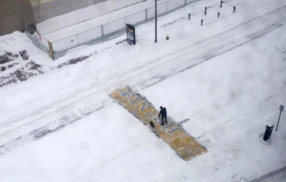 Chris Laudani, a bartender at the Back Bay Social Club, shovels snow from the Boston Marathon finish line on Boylston Street in Boston during Tuesday’s winter storm that slammed eastern Massachusetts with as much as 2 feet of snow.