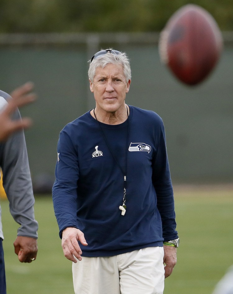 Pete Carroll, coach of the Seattle Seahawks, watches his team run drills Wednesday in Tempe, Ariz. New England Patriots Coach Bill Belichick said there’s “not a coach in the NFL I respect more than Pete Carroll.”