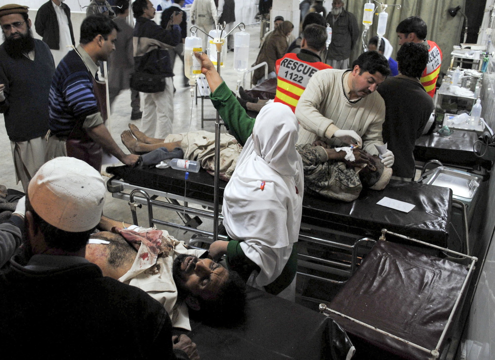 Wounded victims of a suicide bombing are treated at a hospital in Peshawar, Pakistan, in 2010 after a female suicide bomber detonated an explosives-laden vest in a crowded aid distribution center. Terrorist groups have been recruiting women for years, but authorities underestimate them, counterterrorism experts say.