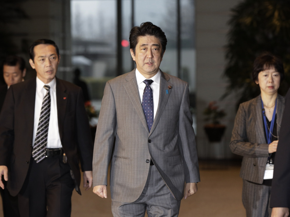 Japan’s Prime Minister Shinzo Abe, center, arrives at his residence in Tokyo on Friday, after a possible prisoner swap wasn’t carried out by Thursday.