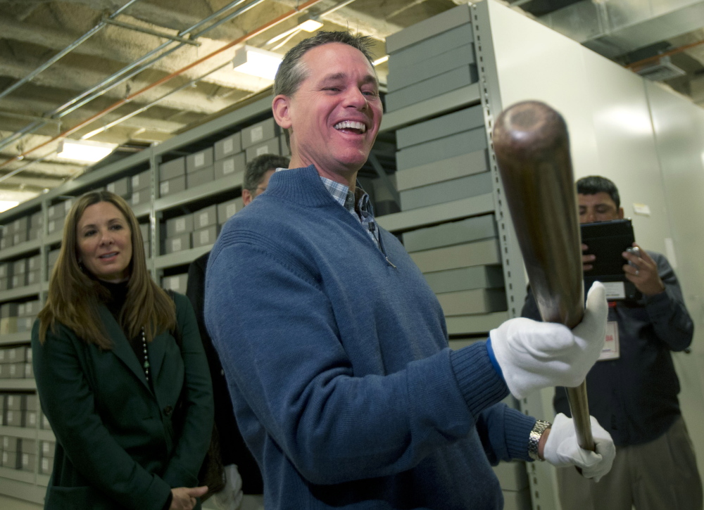 Craig Biggio, who was elected this month to the Hall of Fame, holds Babe Ruth’s bat in the collections area Friday during his orientation visit to Cooperstown, N.Y.