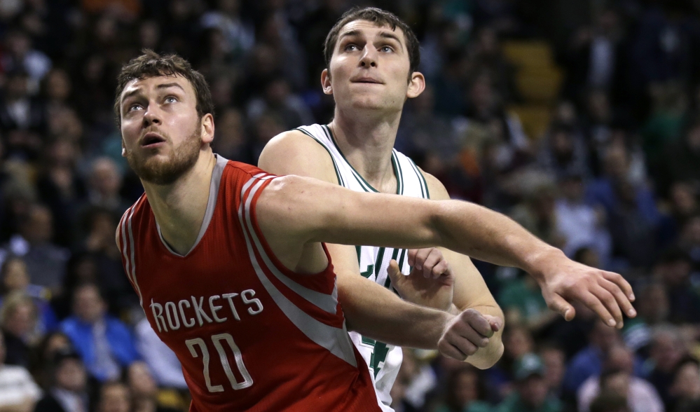 Houston Rockets forward Donatas Motiejunas blocks out Celtics center Tyler Zeller on a rebound during the second quarter of Friday night’s game in Boston. Motiejunas had 26 points in the Rockets’ 93-87 win.