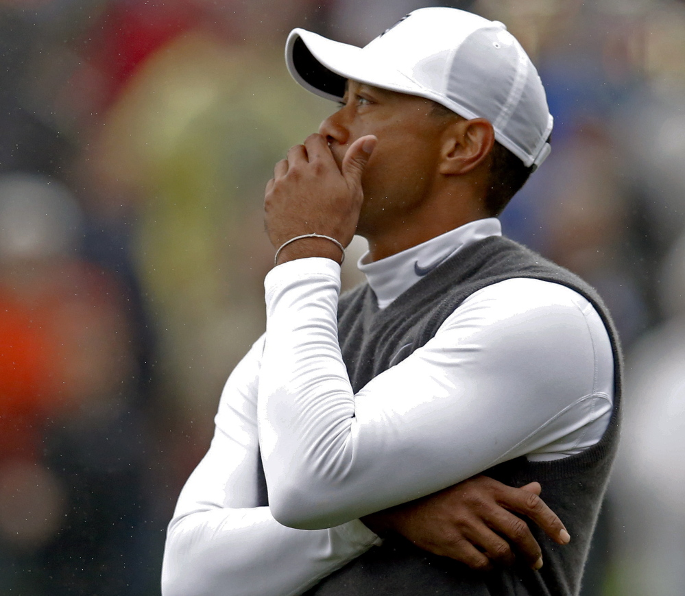 Tiger Woods seems speechless after his putt on the fourth hole didn’t drop Friday at the Phoenix Open, where he missed the cut after a career-high 82.