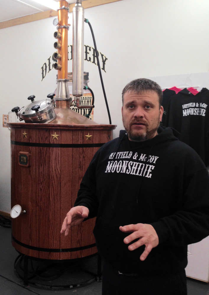 Chad Bishop discusses the distilling process at the Hatfield & McCoy Moonshine distillery on Jan. 22, 2015, in Gilbert, W.Va.