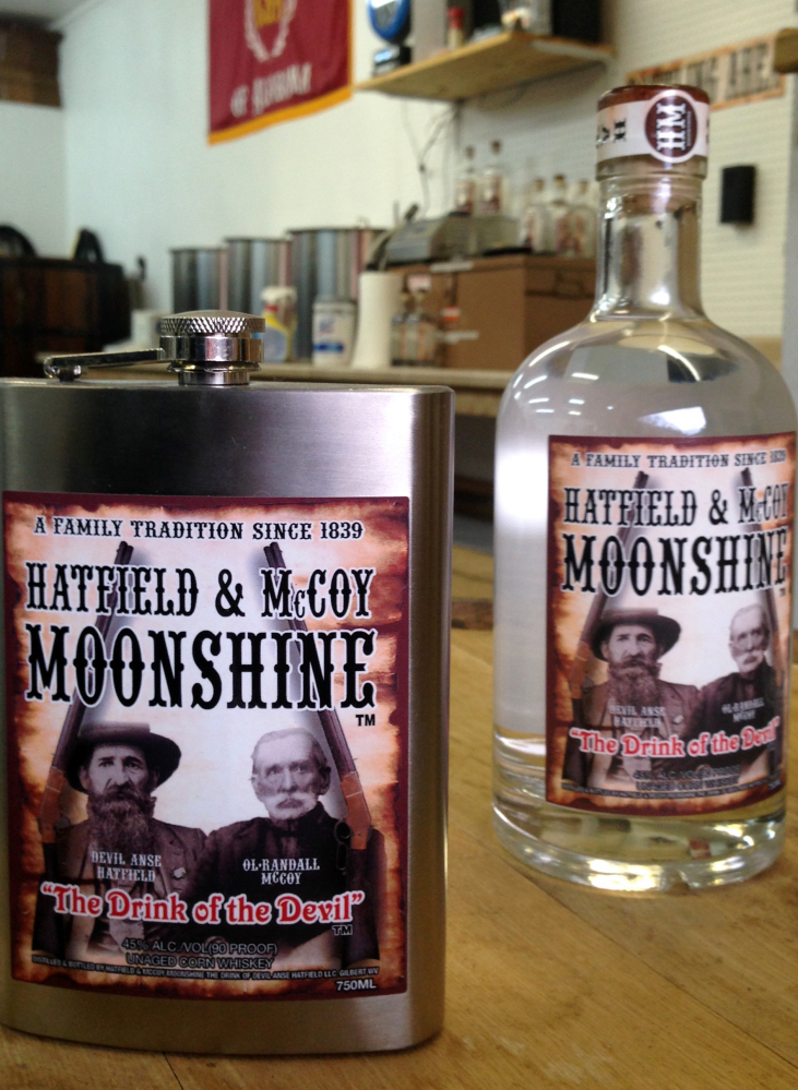 A flask and bottle are shown Jan. 22, 2015, at the Hatfield & McCoy Moonshine distillery in Gilbert, W.Va.