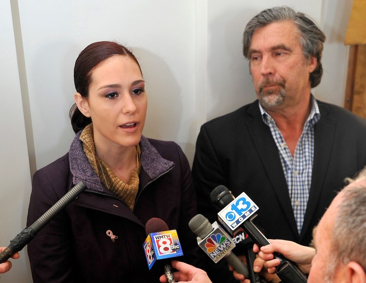 Ashley Summers, whose husband died in the Noyes Street fire, and her attorney, Tom Hallett, discuss the status of their lawsuit after a press conference Wednesday in Portland to announce the fire's cause.  Gordon Chibroski / Staff Photographer)