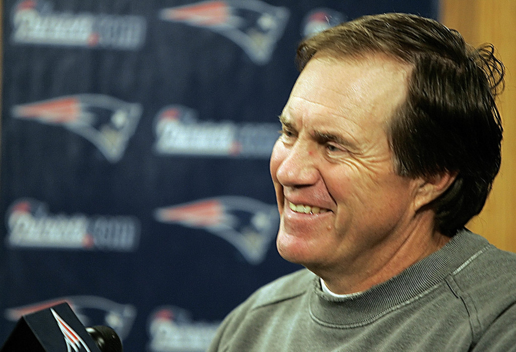 New England Patriots head football coach Bill Belichick smiles as he offers an analogy between the start of a new NFL season and jumping off of a building during a media availability in Foxborough, Mass., Wednesday morning Sept 6, 2006. The Associated Press