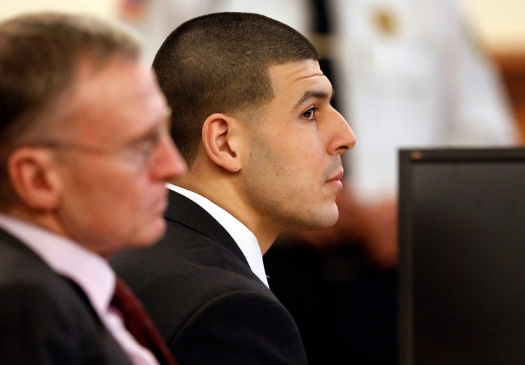 Former New England Patriots football player Aaron Hernandez listens during his murder trial as defense attorney Charles Rankin, left, looks on, Thursday in Fall River, Mass. Hernandez is charged with killing semiprofessional football player Odin Lloyd, 27, in June 2013. The Associated Press