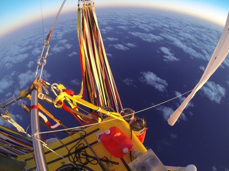 In this photo provided by the Two Eagles Balloon Team, Troy Bradley of New Mexico and Leonid Tiukhtyaev of Russia set off from Saga, Japan, shortly before 6:30 a.m. Sunday in their quest to pilot their helium-filled balloon from Japan  to North America and break two major records en route. The Associated Press
