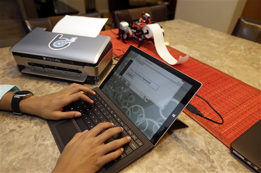 Shubham Banerjee works on a Braigo 2.0 Braille printer prototype. The eighth-grader is believed to be the youngest entrepreneur to receive venture capital funding. The Associated Press