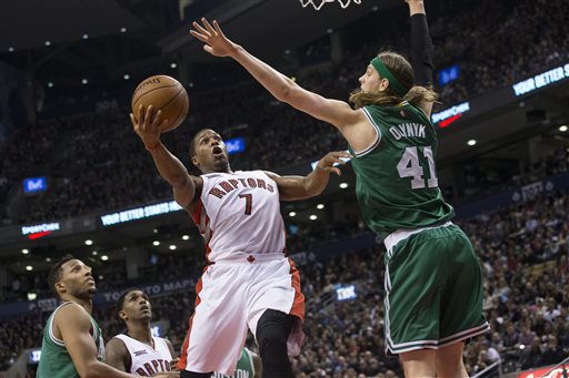 Toronto Raptors' Kyle Lowry scores on Boston Celtics' Kelly Olynyk during the second half Saturday in Toronto. The Associated Press