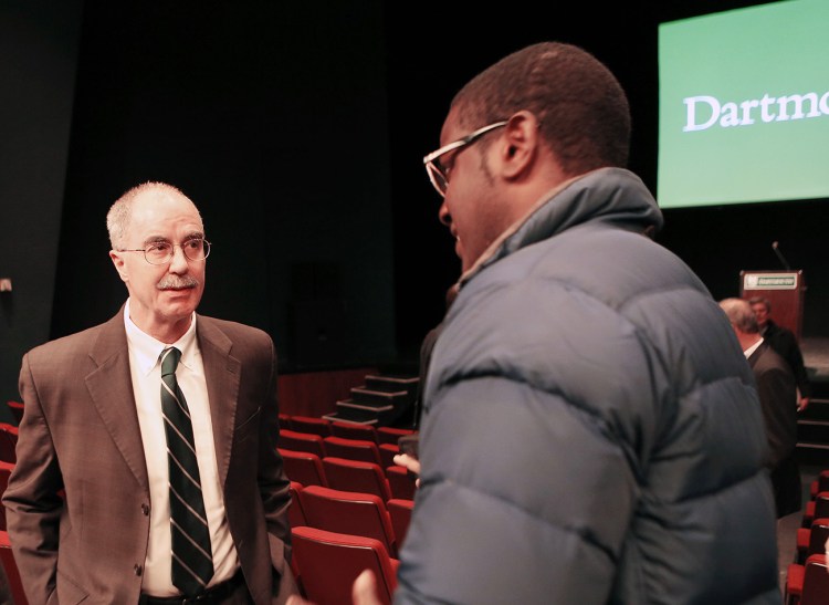 Dartmouth College President Philip Hanlon, left, speaks with a student after telling faculty and students about changes planned for the school Thursday in Hanover, N.H. Dartmouth College banned hard liquor on campus and said all students will have to take part in a sexual violence prevention program all four years they're enrolled at the Ivy League school. The Associated Press