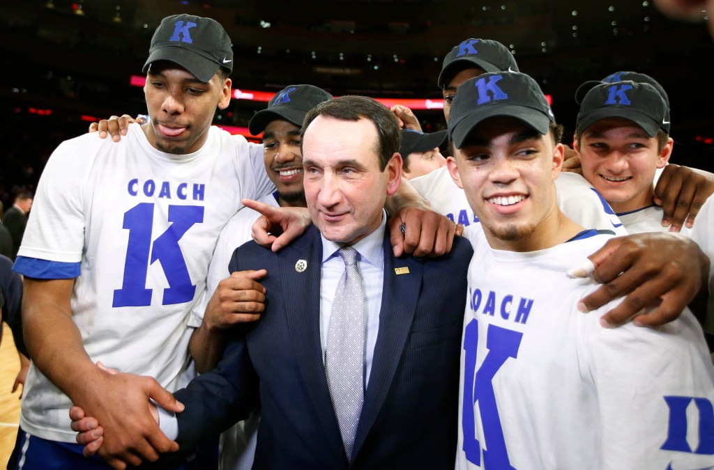 Duke Coach Mike Krzyzewski celebrates with his players after a 77-68 win over St. John’s on Sunday in New York, the 1,000th win of Krzyzewski’s career. The Associated Press