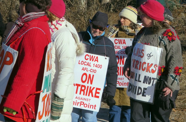 Striking FairPoint Communications workers walk a picket line outside the company's Maine headquarters in Portland last month. 