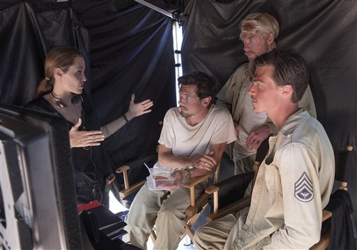 Director Angelina Jolie speaks with actors Jack O'Connell, left, Domhnall Gleeson and Finn Witrock on the set of "Unbroken." Universal Pictures photo
