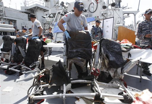 Crew members of Indonesian navy ship KRI Bung Tomo show airplane seats from AirAsia Flight 8501 recovered in search operations for the ill-fated jetliner, during a news conference Monday at the navy's Eastern Fleet Naval Base in Surabaya, East Java, Indonesia. The Associated Press