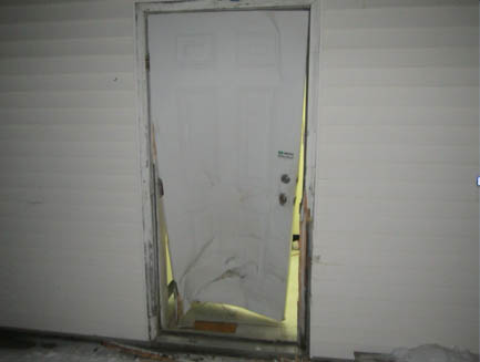 The rear door of the Mt. Blue Drug Store in Farmington shows damage allegedly caused by a man repeatedly ramming it with a pickup truck.