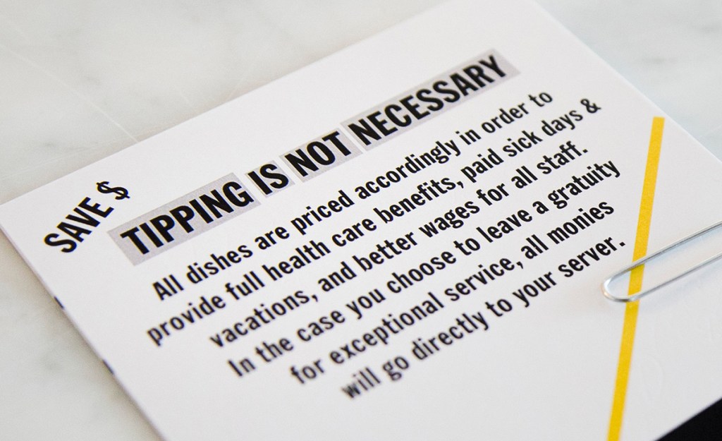A card explaining the no-tip policy is presented with the bill after a meal at Girard's. The Associated Press