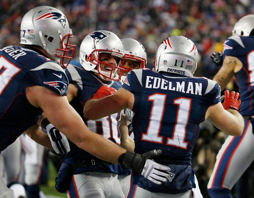 New England Patriots wide receiver Danny Amendola, center, celebrates his 51-yard touchdown pass from Julian Edelman against the Baltimore Ravens Saturday. The Associated Press
