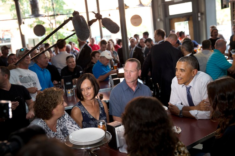 Leslie Gresham, left, Carolyn Reed and David Johnson, all of whom wrote President Barack Obama letters, have dinner with the President  in Denver on  July 8, 2014.  Reed is a guest to watch President Barack Obama's State of the Union address on Capitol Hill Tuesday. The Associated Press