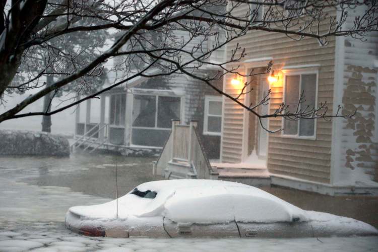 Water floods a street on the coast in Scituate, Mass., Tuesday.