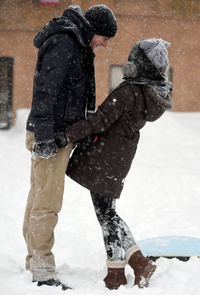 Pear Sutuntanjai, right, and Aaron Gionet play in the snow  in downtown Norwich, Conn., Tuesday. Sutuntanjai is from Thailand and this is her first-ever experience of snow. The Associated Press / The Day, Sean D. Elliot