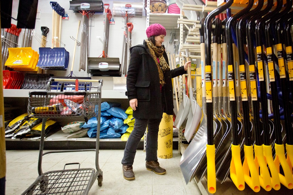 Emily Van Cannon picks up a shovel to purchase at Maine Hardware on St. John Street in Portland Monday. Van Cannon, of South Portland, was shopping for group homes in the area. 