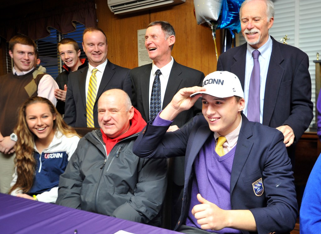 Zordan Holman dons a UConn cap after signing a letter of intent to play for the Huskies. Holman is projected to be a tight end at Connecticut. “I’ll play wherever they need me,” said Holman. Gordon Chibroski/Staff Photographer