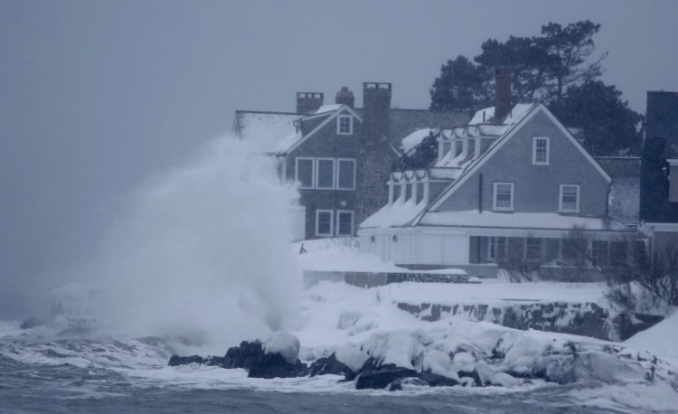 A wave crashes against rocks in front of a seaside home in Kennebunk. The storm kicked up some big surf but coastal flooding was minor in Kennebunk on Sunday morning. Gregory Rec/Staff Photographer