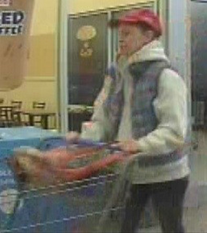 This photo taken from a security camera shows a woman suspected of stealing a television set from the Walmart store in Farmington. 