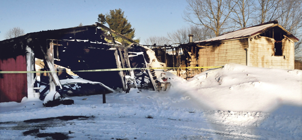 The mobile home and a garage owned by Joyce Bragg were destroyed by fire Thursday. Two cats died in the fire at the home at 28 Albion Road in China.