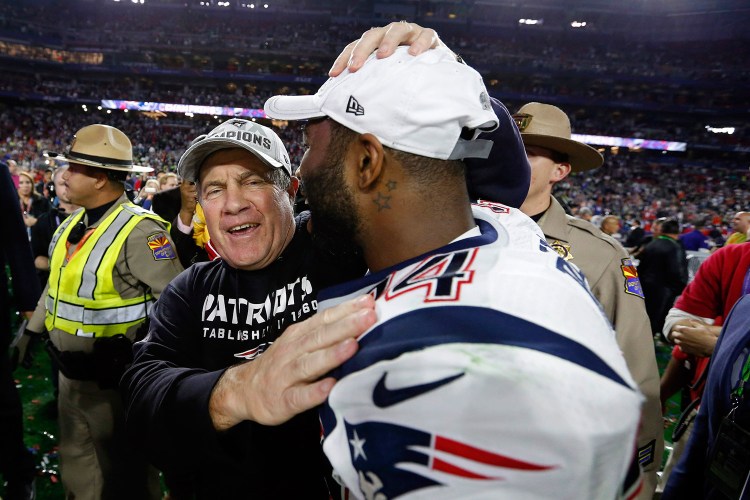 New England Patriots coach Bill Belichick celebrates with cornerback Darrelle Revis after Sunday's Super Bowl victory against the Seattle Seahawks. The team must decide what to do about Revis’ contract, which calls for him to be paid $20 million next season.