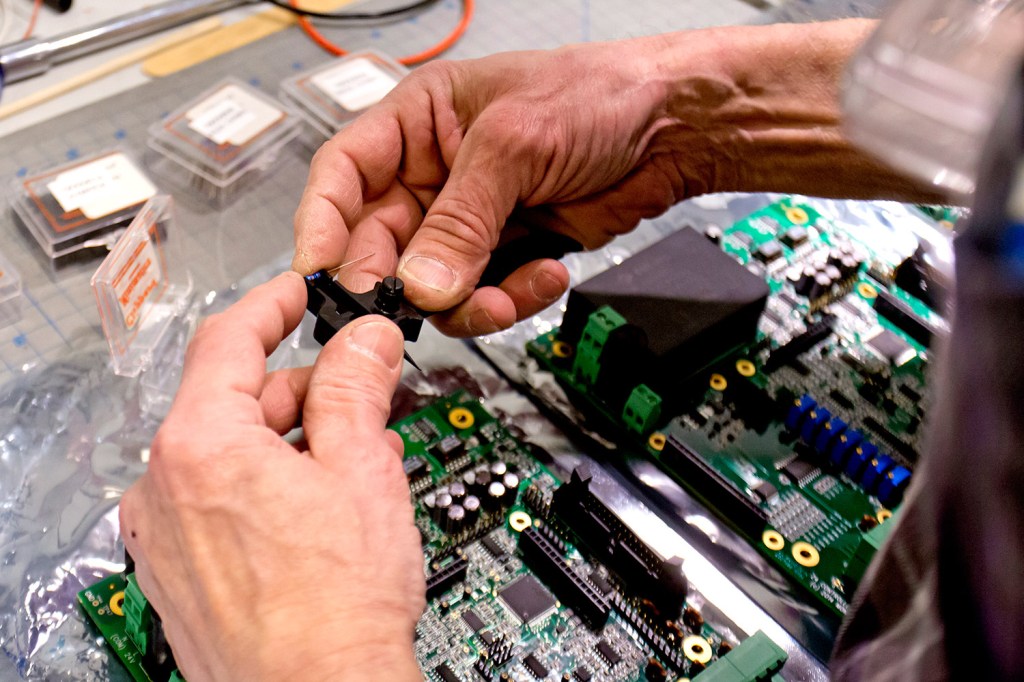 A technician at Montalvo Corporation in Gorham assembles the inside of a Z4 tension controller in 2015.
