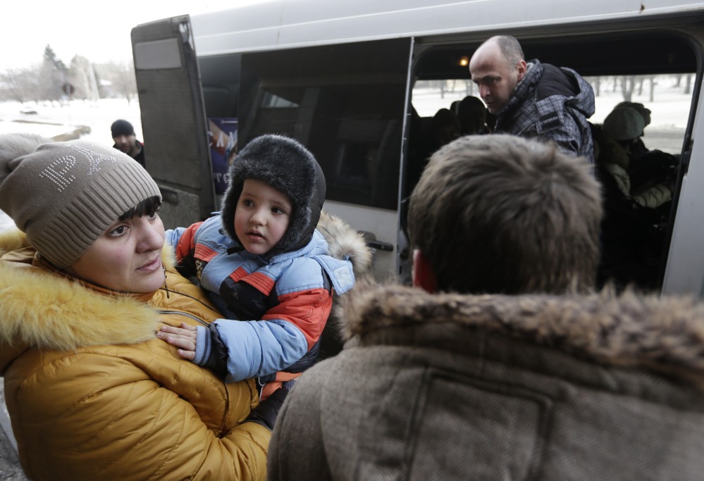 People board a bus to leave Debaltseve, Ukraine, on Saturday. They had gone without power, water and gas for at least 10 days in their embattled town.