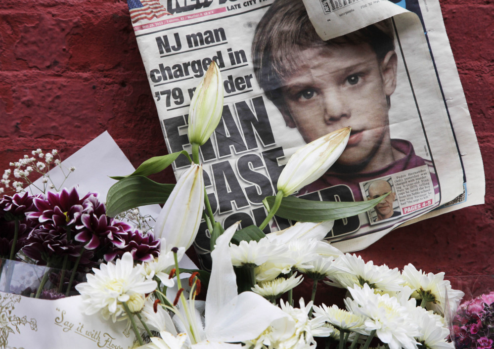 A newspaper from 2012 with a photograph of Etan Patz is among items placed at a makeshift memorial in the SoHo neighborhood of New York where Patz lived before his disappearance on May 25, 1979.