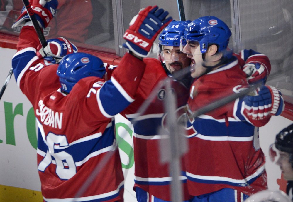 Canadiens left wing Max Pacioretty, right, celebrates with teammates P.K. Subban, left, and Tomas Plekanec after scoring in overtime to lift host Montreal to a 1-0 win over the Capitals. It was Pacioretty’s second straight game with a winning goal.