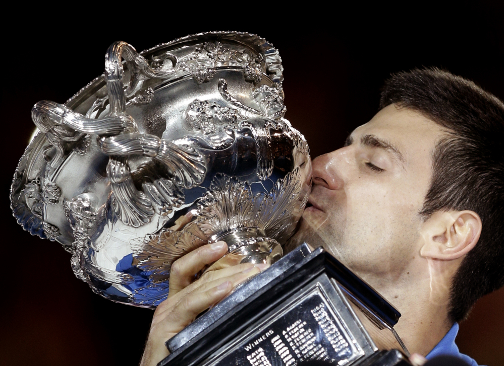 Novak Djokovic kisses the trophy after defeating Andy Murray in during the men’s singles final at the Australian Open in Melbourne, Australia, on Sunday.