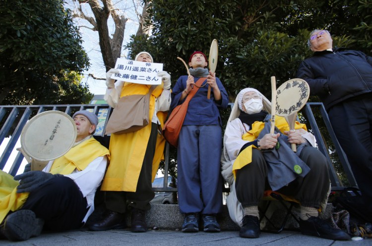 Buddhist monks chant a mantra while beating drums in memory of two Japanese hostages, Kenji Goto and Haruna Yukawa, killed by the Islamic State group, in front of the prime minister’s residence in Tokyo on Monday.