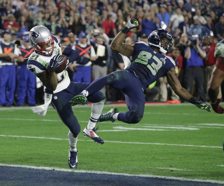 New England Patriots strong safety Malcolm Butler (21) intercepts a pass intended for Seattle Seahawks wide receiver Ricardo Lockette (83) during the second half of NFL Super Bowl XLIX football game Sunday, in Glendale, Ariz.