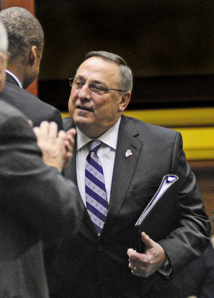 Rep. Craig Hickman, D-Winthrop, greets Gov. Paul LePage as he enters the State House before his speech to a joint legislative session.
